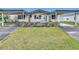 Charming single-story home with well-manicured lawn and front yard flower bed at 200 Patricia Pl, Davenport, FL 33897