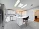 Bright kitchen featuring white cabinets, stainless steel appliances, an island and unique mosaic floors at 200 Patricia Pl, Davenport, FL 33897