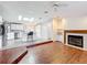 Bright and airy living room with wood floors, fireplace, and open layout to the kitchen at 200 Patricia Pl, Davenport, FL 33897