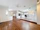 Open-concept living room view to the kitchen featuring hardwood floors and a bright, airy feel at 200 Patricia Pl, Davenport, FL 33897