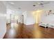 Inviting living room featuring wood floors, ceiling fan and light-filled open space at 200 Patricia Pl, Davenport, FL 33897
