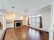 Inviting living room with wood floors, fireplace, built-in shelves, and large windows at 200 Patricia Pl, Davenport, FL 33897