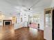 Open-concept living room with wood floors, fireplace and glass doors to the sunroom at 200 Patricia Pl, Davenport, FL 33897