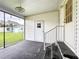 Covered porch showing the stairs to the entrance with a screen room at 200 Patricia Pl, Davenport, FL 33897