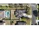 Aerial view of a house with solar panels, a driveway, and a backyard pool at 2005 Blackbird Dr, Apopka, FL 32703