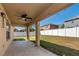 Covered patio with a ceiling fan, string lights, and a view of the fenced backyard at 2005 Blackbird Dr, Apopka, FL 32703