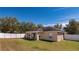 Backyard of home featuring a covered patio, privacy fence, and a lush lawn perfect for outdoor activities at 2005 Blackbird Dr, Apopka, FL 32703