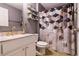 Stylish bathroom with a vanity, hexagon shower curtain, marble countertop, and gold fixtures at 2005 Blackbird Dr, Apopka, FL 32703