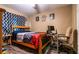 Bright bedroom with wood-look floors, computer desk, and a bed with colorful bedding, perfect for relaxation at 2005 Blackbird Dr, Apopka, FL 32703