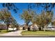 Charming single-story home with solar panels and a well-manicured lawn surrounded by mature trees at 2005 Blackbird Dr, Apopka, FL 32703