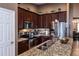 Well-equipped kitchen featuring granite countertops, stainless steel appliances, and wood cabinets at 2005 Blackbird Dr, Apopka, FL 32703