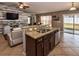 Open concept kitchen with granite countertops, stainless steel sink, and dark wood cabinets at 2005 Blackbird Dr, Apopka, FL 32703