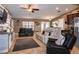Spacious living room with tiled floors, neutral furniture, and views of the kitchen and backyard at 2005 Blackbird Dr, Apopka, FL 32703