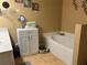 Bathroom featuring a vanity, jacuzzi tub and decorative mirror on the wall at 203 Flounder Pl, Kissimmee, FL 34759