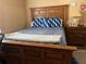 Spacious bedroom with an oversized bed, a wooden headboard, and comfortable blue patterned bedding at 203 Flounder Pl, Kissimmee, FL 34759