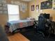 Bedroom features a dark gaming chair, computer and desk with natural light and modern flooring at 203 Flounder Pl, Kissimmee, FL 34759