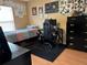 Bedroom features a dark gaming chair, computer and desk with natural light and modern flooring at 203 Flounder Pl, Kissimmee, FL 34759