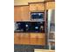 This classic kitchen is equipped with stainless appliances, granite countertops, and wood cabinets at 203 Flounder Pl, Kissimmee, FL 34759
