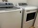 Laundry room featuring a white washer and dryer set ready for use in a well-lit space at 203 Flounder Pl, Kissimmee, FL 34759