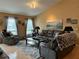 Warm living room showcasing a plush leather sofa, recliner chairs, and a soft, neutral-toned rug at 203 Flounder Pl, Kissimmee, FL 34759