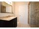 Bathroom featuring a granite countertop vanity and glass-enclosed shower at 206 E South St # 1018, Orlando, FL 32801