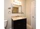 Bathroom features a granite countertop vanity, framed mirror, and a shower visible in the mirror at 206 E South St # 1018, Orlando, FL 32801