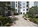 Beautifully landscaped courtyard featuring a fountain, benches, and paved walkways at 206 E South St # 1018, Orlando, FL 32801