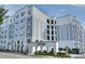 Modern condo building exterior with manicured landscaping and a welcoming arched entrance at 206 E South St # 1018, Orlando, FL 32801