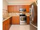 Well-equipped kitchen featuring stainless steel appliances and wooden cabinetry at 206 E South St # 1018, Orlando, FL 32801