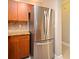 Stainless steel fridge and wooden cabinets in this modern kitchen at 206 E South St # 1018, Orlando, FL 32801