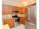 Well-equipped kitchen featuring stainless steel appliances and wooden cabinetry at 206 E South St # 1018, Orlando, FL 32801