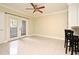 Open concept living room features tiled flooring, neutral paint, and outdoor access at 206 E South St # 1018, Orlando, FL 32801