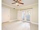 Bright living space with tiled floor, ceiling fan, and access doors to the exterior at 206 E South St # 1018, Orlando, FL 32801