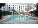 Serene pool reflecting the surrounding building, complemented by lush greenery at 206 E South St # 1018, Orlando, FL 32801