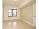 Well-lit room with tiled floor and a large window with dark blinds at 206 E South St # 1018, Orlando, FL 32801