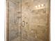 Tiled shower stall with glass door and adjustable shower head and built-in shelves at 206 E South St # 1018, Orlando, FL 32801