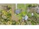 Aerial view of property with mature trees, a large yard, storage shed and a driveway at 20639 Sw Rainbow Lakes Blvd, Dunnellon, FL 34431