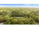 Aerial view of a home surrounded by lush forest and greenery at 20639 Sw Rainbow Lakes Blvd, Dunnellon, FL 34431