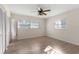 Bright bedroom with wood floors, ceiling fan, and two windows providing plenty of natural light at 20639 Sw Rainbow Lakes Blvd, Dunnellon, FL 34431
