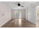 Inviting bedroom with a ceiling fan, wood-style flooring, and double doors to the outside at 20639 Sw Rainbow Lakes Blvd, Dunnellon, FL 34431