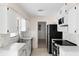 Well-organized kitchen with white cabinets, modern marble-style countertops, and stainless steel appliances at 20639 Sw Rainbow Lakes Blvd, Dunnellon, FL 34431
