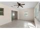 Sun room with tile floor, a ceiling fan, sliding door and large windows, filling the space with natural light at 20639 Sw Rainbow Lakes Blvd, Dunnellon, FL 34431