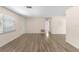 Bright living room featuring wood flooring, large window, and fresh neutral paint at 20639 Sw Rainbow Lakes Blvd, Dunnellon, FL 34431