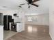 Open floor plan showcasing the kitchen with stainless steel appliances and the well-lit living room at 20639 Sw Rainbow Lakes Blvd, Dunnellon, FL 34431