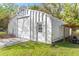 The metal outbuilding features a garage door and a personnel door at 20639 Sw Rainbow Lakes Blvd, Dunnellon, FL 34431