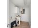 Practical utility room with wood-style flooring, functional sink, and ample storage space at 20639 Sw Rainbow Lakes Blvd, Dunnellon, FL 34431
