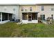 Private backyard featuring a screened lanai, lush green lawn, and partial fencing at 2722 Dodds Ln, Kissimmee, FL 34743