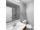 This bathroom features a vanity with a sink, toilet, and a shower with sliding glass doors and marble-look tiling at 2722 Dodds Ln, Kissimmee, FL 34743