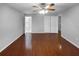 Bright and airy bedroom with gleaming wood floors, ceiling fan, and ensuite bathroom at 2722 Dodds Ln, Kissimmee, FL 34743