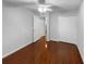 A spare bedroom featuring hardwood floors, a window, a ceiling fan, and a closet at 2722 Dodds Ln, Kissimmee, FL 34743